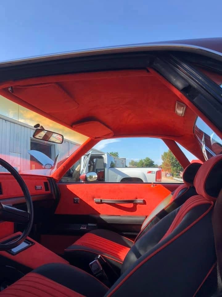Full red and black interior reupholstery on a classic car, done by Ramon