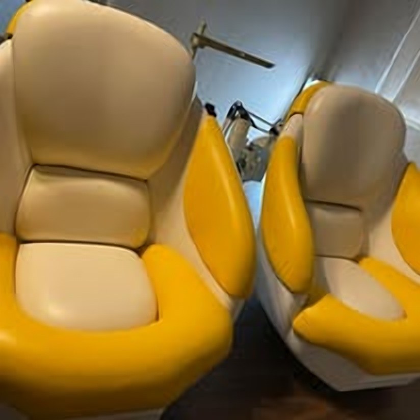 Boat captain's chairs reupholstered in yellow and cream marine vinyl